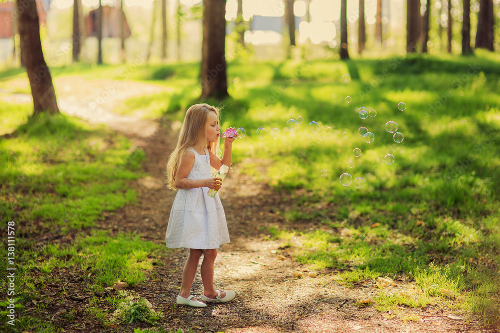Portrait of funny lovely little girl blowing soap bubbles Portrait of funny lovely little girl blowing soap bubbles