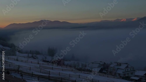 Dawn fog village winter forest photo