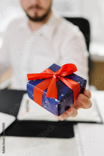 Business man with gifts businessman offering a gift to you