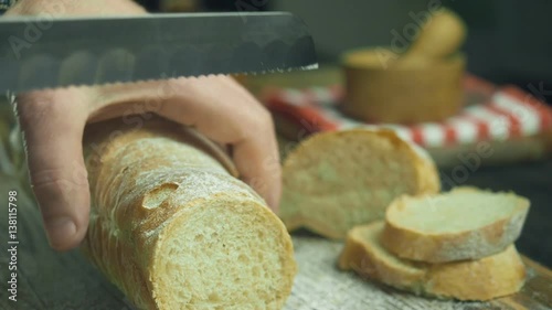 Cut slice of bread in slow motion, close up