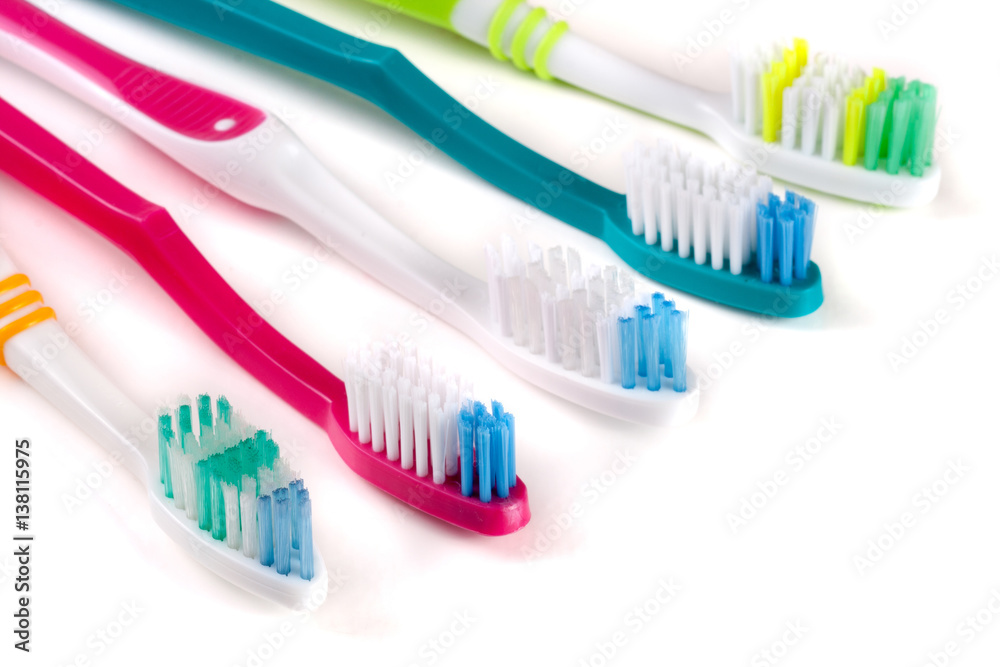 Five toothbrushes isolated on a white background closeup Five toothbrushes isolated on a white background closeup
