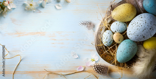 Easter background with Easter eggs and spring flowers. Top view with copy space photo