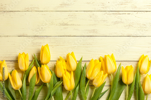 Yellow tulips on wooden background
