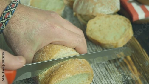 Cut slice of bread in slow motion, close up