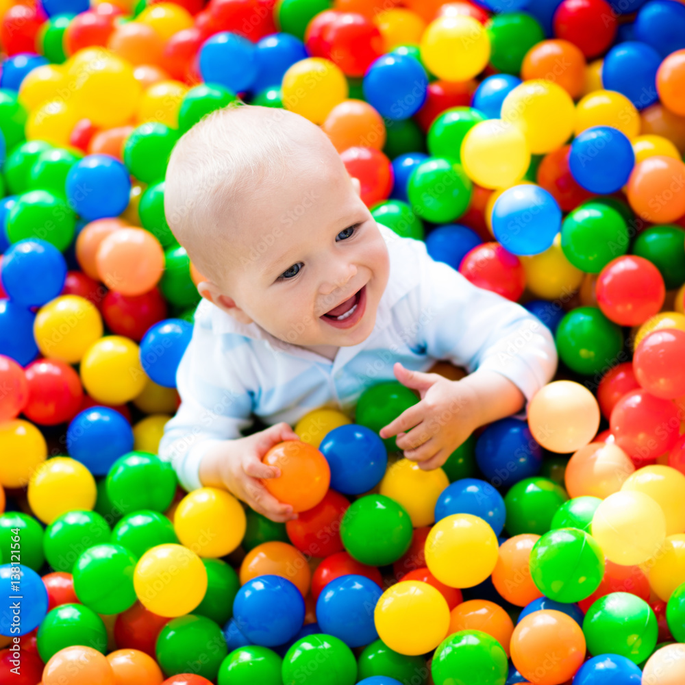 Child playing in ball pit on indoor playground Child playing in ball pit on indoor playground