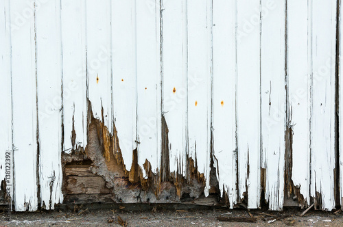 A white painted wood facade which is rotten photo