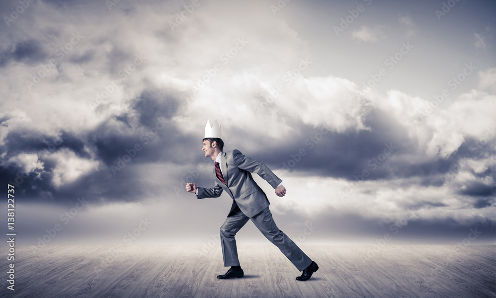 King businessman in elegant suit running and blue sky at backgro