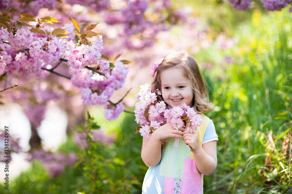 Little girl with cherry blossom