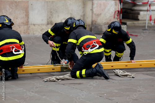 firefighters with ladder to reach the upper floors of the build