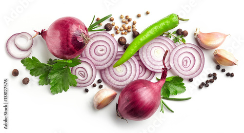 red onions, garlic and various spices on white background