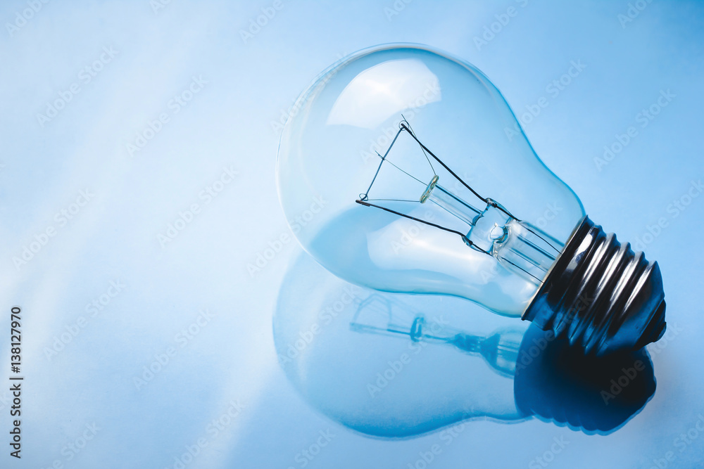 Light bulb on glossy reflective glass surface. Light bulb on glossy reflective glass surface.