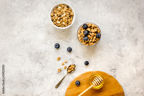 Oat flakes and berries granola glass on table background top view