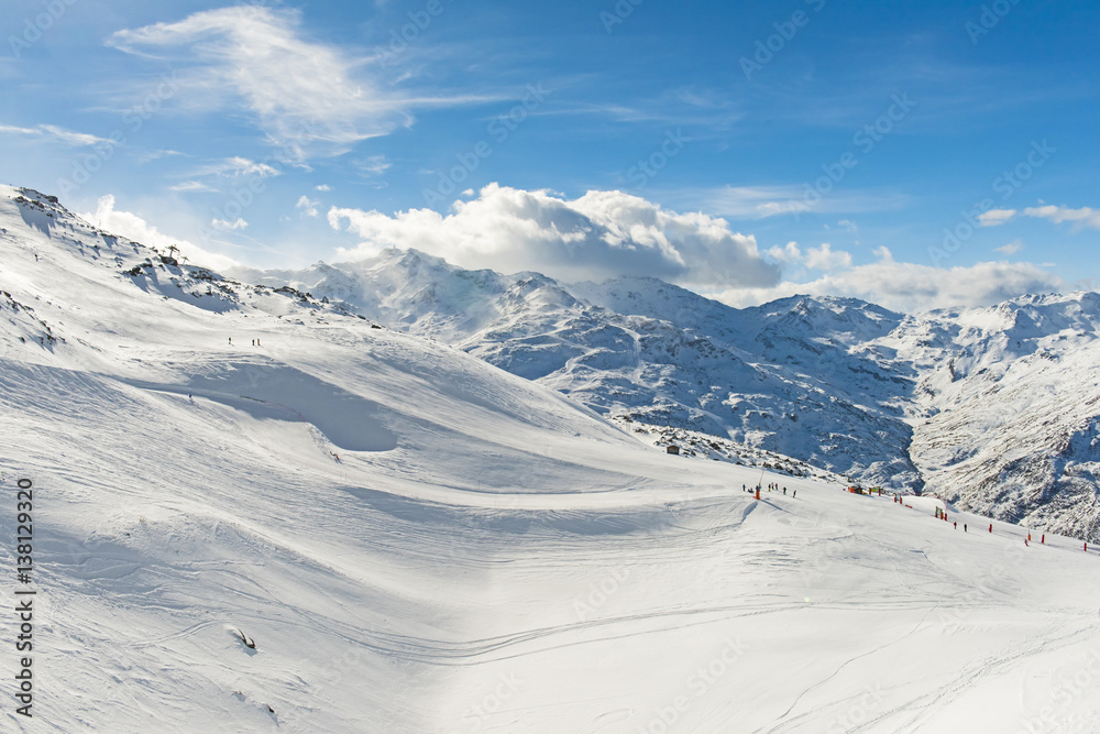 Skiers on a piste in alpine ski resort