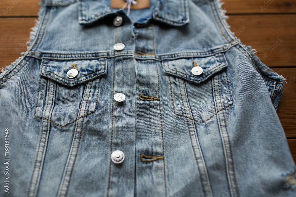close up of denim vest or waistcoat on wood close up of denim vest or waistcoat on wood
