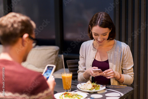happy couple having dinner at vegan restaurant