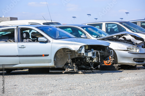 several cars in a scrap yard available for spare parts