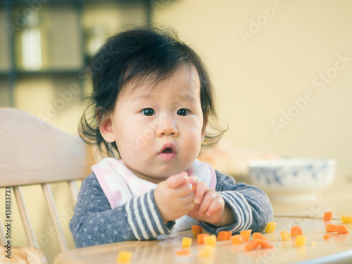 baby girl eating vegetable first time