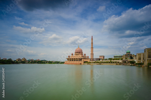 A Mosque by a lake on a sunny day