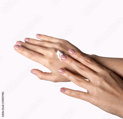 Beautiful young woman hands with cream, isolated on white.