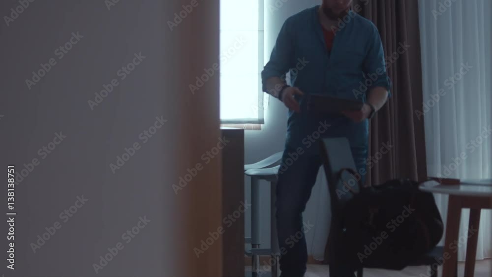 WIDE Caucasian male packing travel bag at home. 4K UHD RAW edited footage