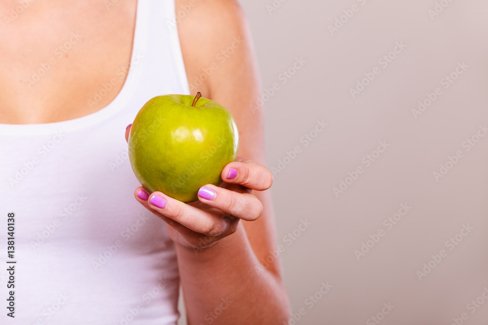 Fit woman holding apple fruit, dieting concept Fit woman holding apple fruit, dieting concept