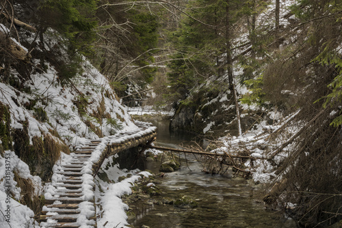 Biely creek with bridges and big hills photo