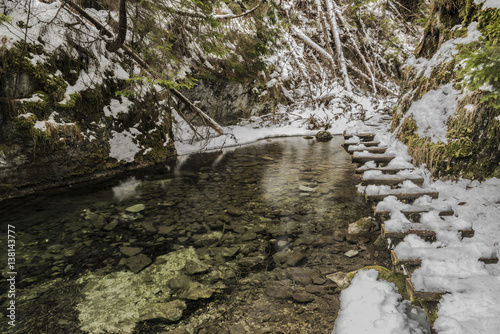 Biely creek with bridges and big hills photo