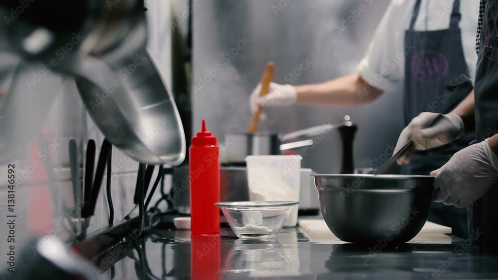 Two chefs working in a restaurant kitchen. Two chefs working in a restaurant kitchen.