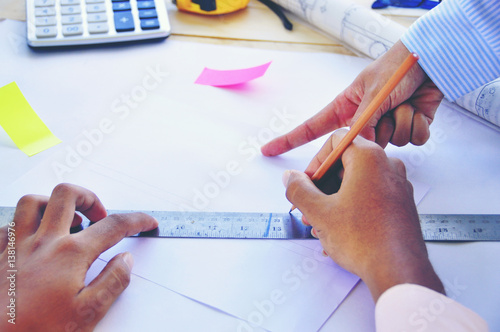 Wallpaper Mural A young Asian consultant  Architect drawing on architectural project business, architecture, building, construction and people concept - close up of architect hands with blueprint Torontodigital.ca