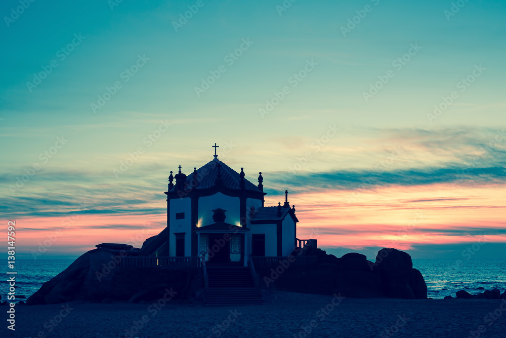 Chapel Senhor da Pedra at dusk, Miramar Beach, Portugal.