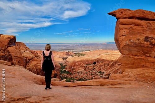 Woman in sandstone desert. Arches National Park. Devil's Garden. Moab. Utah. United States.