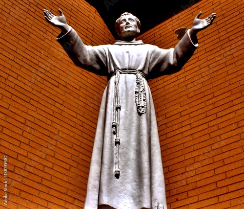 Religious statue with hands reaching out. 