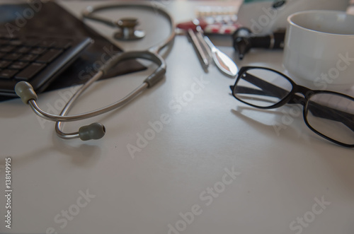 stethoscope and Medical equipment , film x-ray, cup coffee. Doctor workplace in office .
