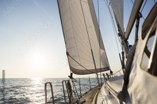 Luxury Sail Boat Sailing In Open Sea During Sunrise © Tyler Olson