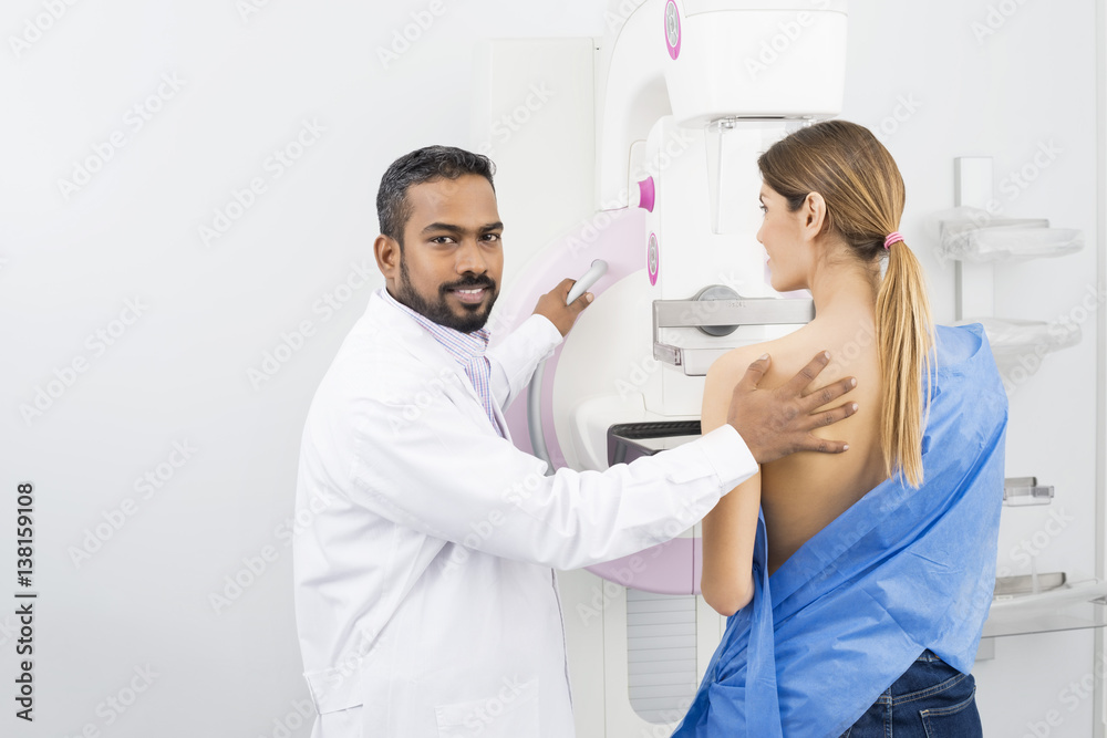 Doctor Standing Assisting Patient Undergoing Mammogram X-ray Tes Doctor Standing Assisting Patient Undergoing Mammogram X-ray Tes