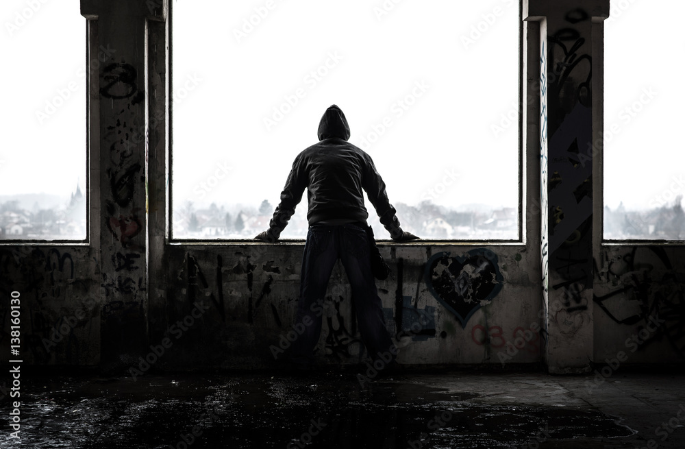 Fotografie Man standing in old abandoned ruin
