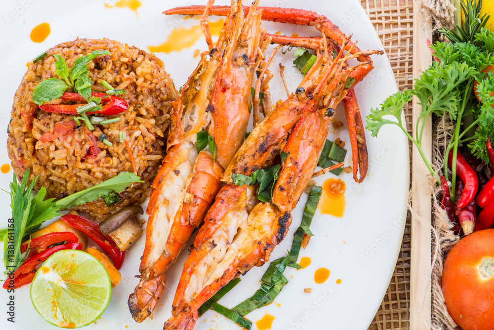 Asian fried rice nasi goreng with chicken, prawns, egg and vegetables, Thai cuisine Asian fried rice nasi goreng with chicken, prawns, egg and vegetables, Thai cuisine