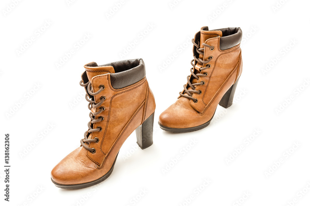 Yellow heeled ankle boots with laces isolated on white background.