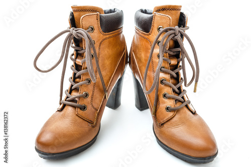 Yellow heeled ankle boots with laces isolated on white background.