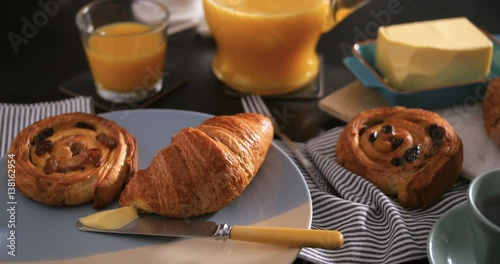 Dolly view of a French breakfast with pastries, orange juice and coffee