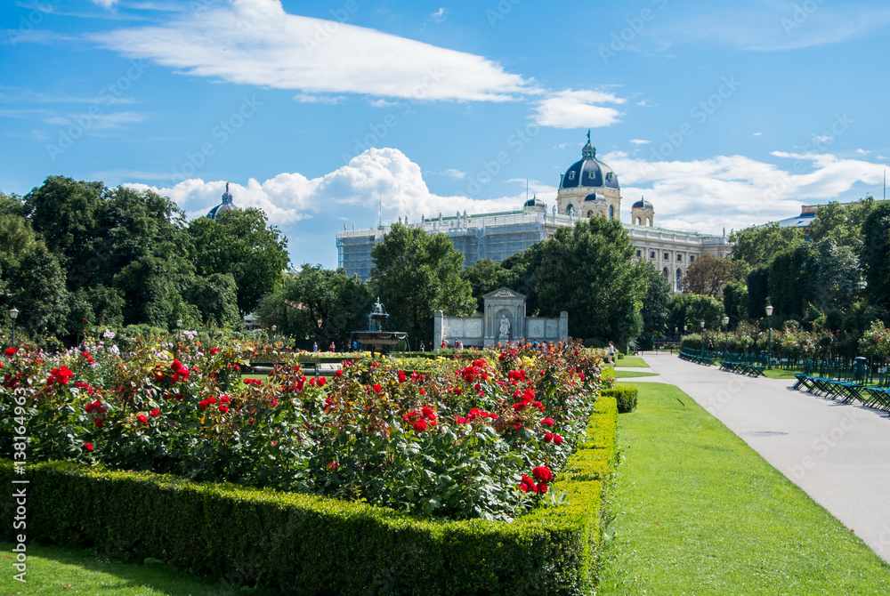 A view of Volksgarten park with flowering red roses in front of Hofburg, Vienna, Austria.