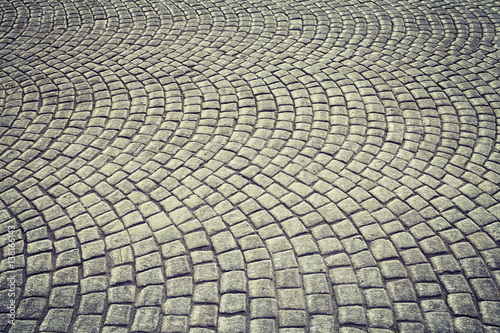 Vintage toned old cobblestone pavement background.