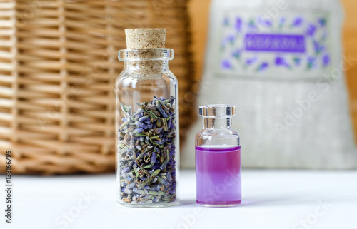 Two small bottles with dry lavender buds and essential aroma oil (perfume, tincture, infusion, extract). Aromatherapy and spa ingredients.