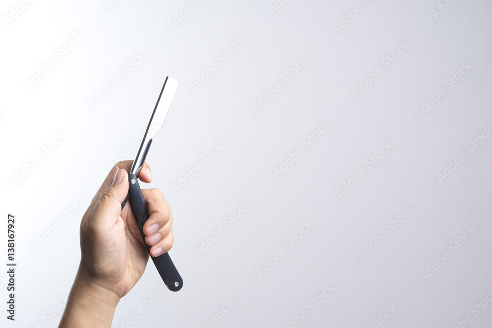 Hand holding razor use in barber Hand holding razor use in barber