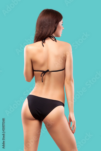 Sexy blonde woman wearing swimwear posing on color background. Perfect body. Bikini catalogue. © Mike Orlov