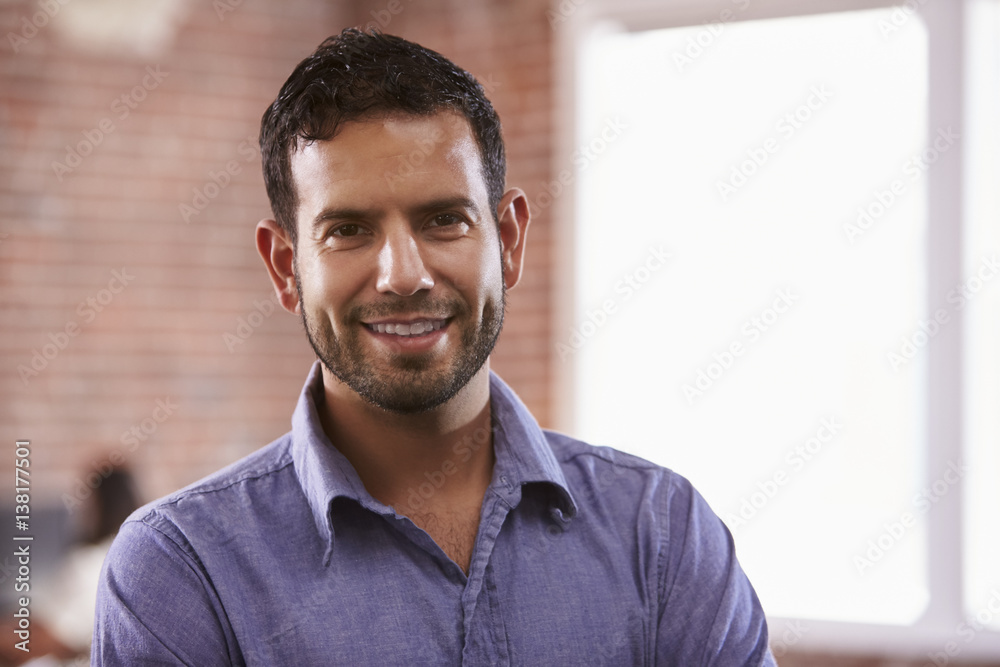 Portrait Of Businessman In Office Standing By Window