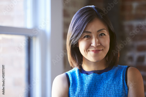 Portrait Of Businesswoman In Office Standing By Window photo