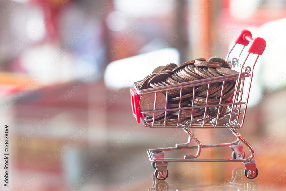 Finance and money concept mini shopping cart red blurry background