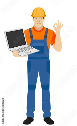 Builder with laptop show a okay hand sign