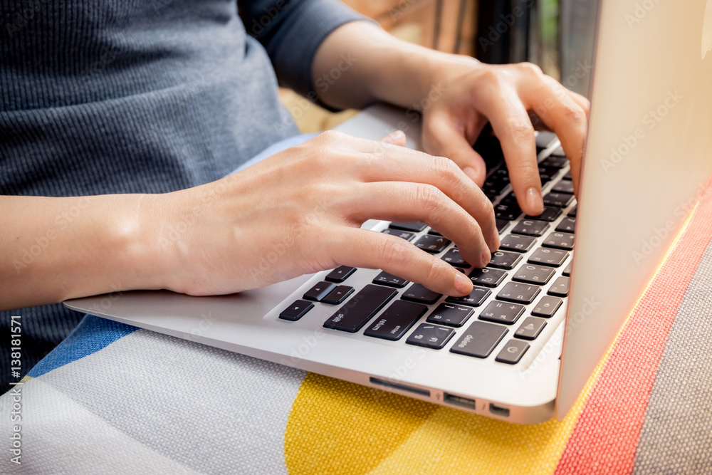 Relaxed young woman typing on a laptop at home as she sit on a comfortable sofa. Relaxed young woman typing on a laptop at home as she sit on a comfortable sofa.